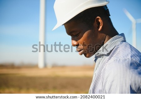 Engineer African man standing with wind turbine