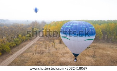 Hot air baloon over the colorful autumn trees. Concept for fall background. Artistic picture. Great idea for travel.