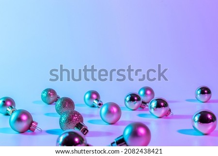 Christmas balls pattern neon background. Xmas bauble on abstract holiday winter gradient backdrop. Happy new year copy space