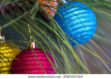 closeup christmas toys on pine tree branch, new year natural background