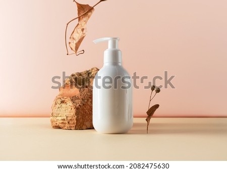Bottle, brick and dry autumn leaf creative still life cosmetic photography