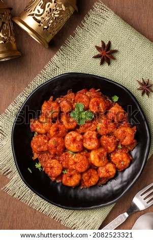 Top view spicy hot Bengali Prawn roast , shrimp masala fish curry Indian food. Fish fry red chili, curry leaf. Asian cuisine. Delicious Kerala Goan fish curry. Grilled tiger shrimps Royalty-Free Stock Photo #2082523321