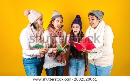Posada Mexicana, Mexican family Singing carols at Christmas, three generations of women in Mexico Latin America
