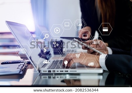 
Business team partnership meeting concept. Business hand using laptop, tablet and smartphone  in office. Digital marketing media mobile app in virtual icon screen in morning light
