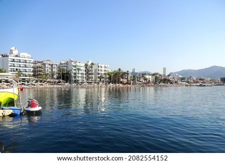 Panorama of the resort town of Marmaris - coastline with hotels in the rays of the sun on the coast of the sea bay