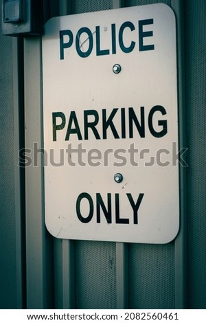 Black and white aged photo of police parking sign