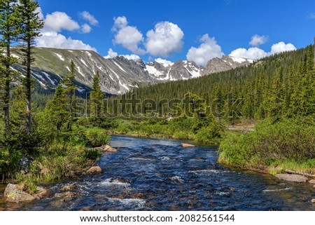 Spring Mountain Creek - South Saint Vrain Creek at Long Lake, with Indian Peaks towering in background, on a sunny Spring morning. Indian Peaks Wilderness, Colorado, USA. Royalty-Free Stock Photo #2082561544