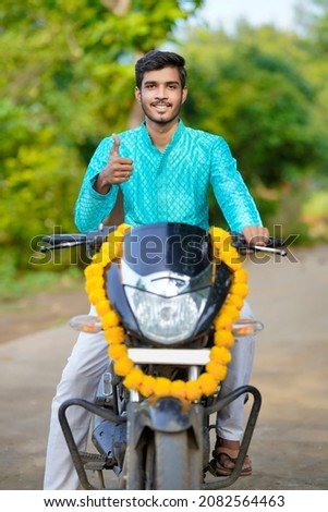 Young indian boy with new bike Royalty-Free Stock Photo #2082564463