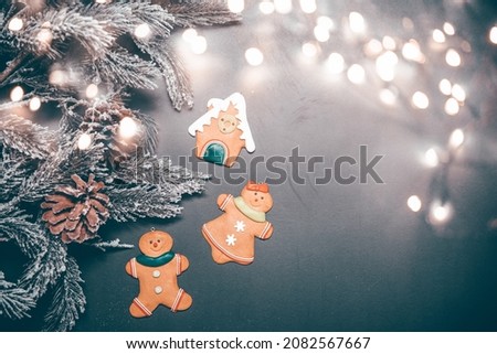 Christmas holidays with snowy branches and gingerbread cookies and space for text