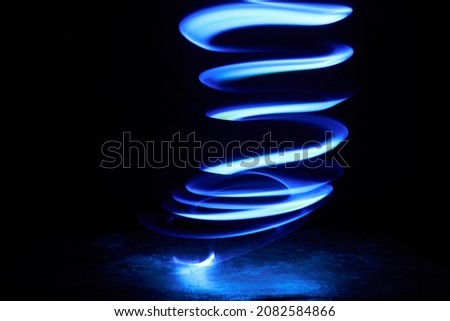 Magic blue light spirals in the dark Royalty-Free Stock Photo #2082584866