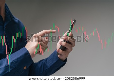 Trader, investor, businessman pointing smartphone on online trading platform with technical financial price graph, stock market or Cryptocurrency trading chart, choose to money trade with copy-space. Royalty-Free Stock Photo #2082586999