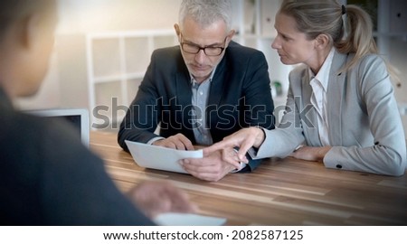 young couple signing a contract for a real estate purchase