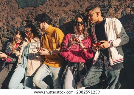 Gen z friends carefree talking and browsing social media contention the smartphones - young people sharing internet contents outdoors Royalty-Free Stock Photo #2082591259
