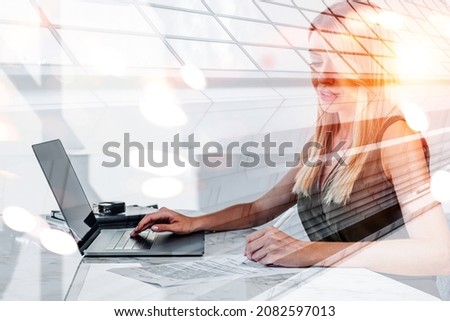 Office woman writing in business paper, signing a contract. Hand on laptop keyboard, double exposure with office hall. Desk with document and technology. Concept of business secretary