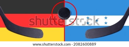 Top view hockey puck with Germany vs. Honduras command with the sticks on the flag. Concept hockey competitions