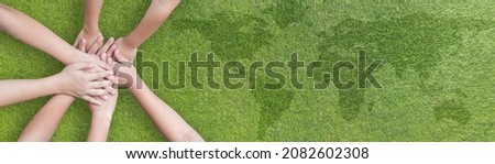 Environmental, social and corporate governance ESG, CSR and SDG Sustainable Development Goal on energy saving collaboration of children teamwork hands on green background for World environment day Royalty-Free Stock Photo #2082602308