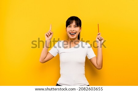Education and the joy of learning A young Asian woman with a smile and knowledge to study. happiness of ideas on a yellow background educational concept