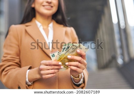 Woman holding euro money. Female counting money euro banknotes.  Royalty-Free Stock Photo #2082607189