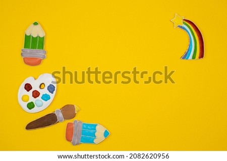 Gingerbread cookies in the form of drawing accessories. Stationery tools for schools and artists. Palette, paints, brush, pencils, rainbow, stars. Sweet cake decorations. The first of September. 