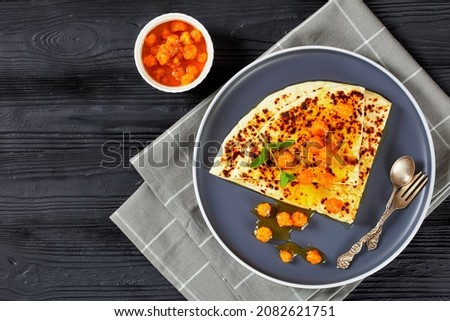 Leipajuusto, kaffeost, bread cheese, finnish squeaky cheese slices with cloudberry jam and fresh mint on a white plate on a black wooden table, flat lay, free space Royalty-Free Stock Photo #2082621751