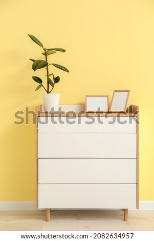 Chest of drawers near color wall in room