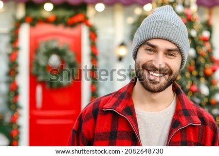 Handsome young man outdoors on Christmas eve