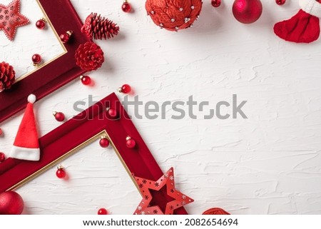 Christmas red picture frame and bauble decoration ornament on white concrete table background