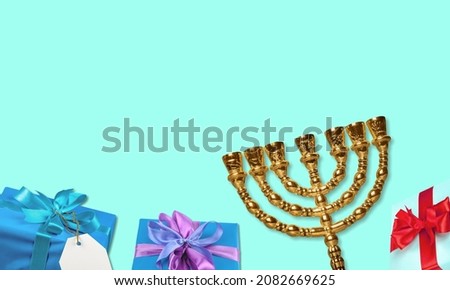 Jewish holiday Hanukkah background with a menorah and gift box on table