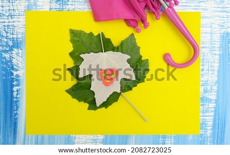 Autumn crafts. Child making fun heart from plasticine and use natural leaves and  paper. Back to school. Ideas for children's art