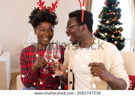 Couple celebrate the New Year and Christmas holidays by taking selfies. Dry white wine champagne in glasses. Happy young couple. Loving couple toasting with Champagne and celebrating Christmas