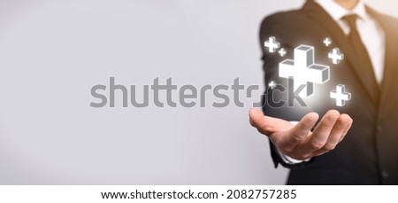 Businessman, man hold in hand offer positive thing such as profit, benefits, development, CSR represented by plus sign.The hand shows the plus sign.