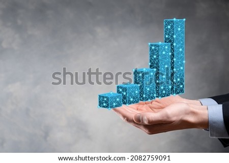 Business man holding 3D graphs low polygonal and stock market statistics gain profits. Concept of growth planning,business strategy.economic growing concept.Business strategy. Digital marketing