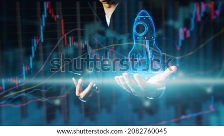 Businessman or merchant showing hologram stock with the direction of rising like a rocket in hand Finance concept, stock market, fast growing business like a rocket. 