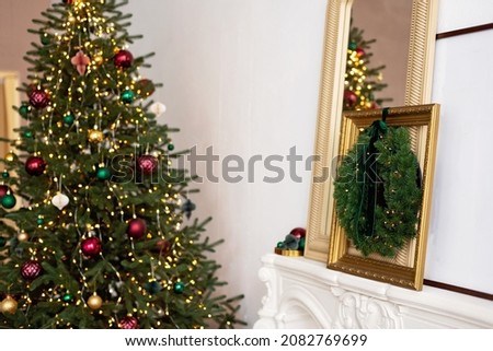 Christmas modern decor. The interior is decorated with garlands, a fireplace, Christmas wreaths .New Year in a contemporary style. Soft selective focus.