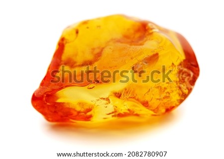 Natural amber. A piece of yellow opaque natural amber on white background. Royalty-Free Stock Photo #2082780907