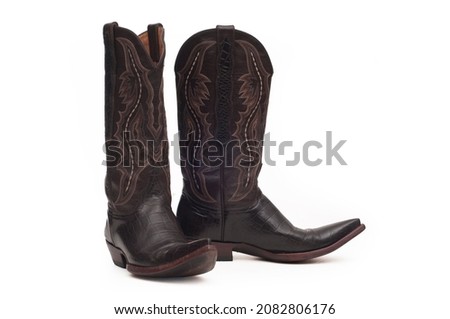 Leather cowboy boots on white background Royalty-Free Stock Photo #2082806176