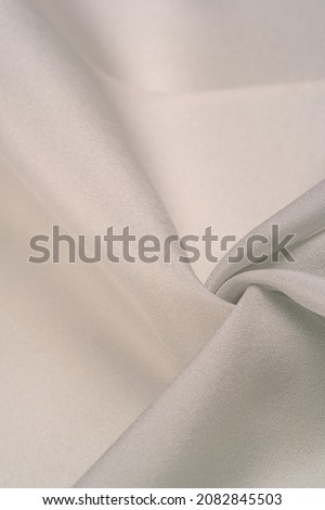 Steel soft cream silk in a combination of cotton and silk, with a background pattern of light pale cream shades, sepia beige. Background texture