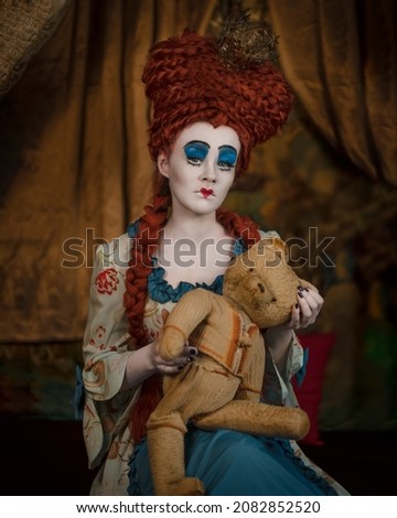 Cosplay Queen of Hearts with a bear based on the book Alice in Wonderland