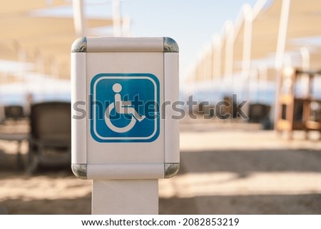 Disability sign on the sea beach. Beach places for people with disabilities. The sign for the disabled there are places for people with disabilities.