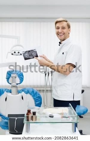 Picture of young woman doctor dentist who analysis dental x ray orthopantomogram. Dental panoramic radiography