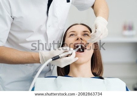 Overview of dental caries prevention, Girl at the dentist chair during a dental scaling procedure, Healthy Smile. Royalty-Free Stock Photo #2082863734