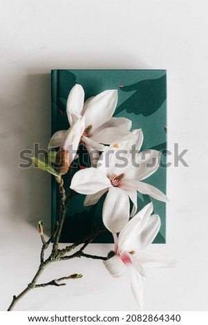 spring , book and flower  , floral , green background, energized,  awakening, rebirth, warmer ,blissful 