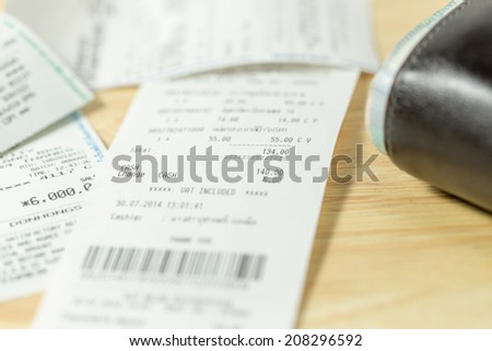 The cash voucher and wallet on wood board