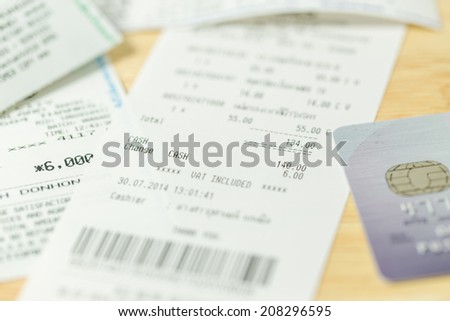 The cash voucher and credit card on wood board.