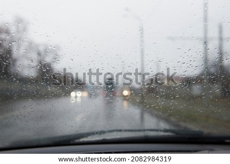 raindrops on the glass of the car. Poor visibility on the road during rain