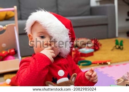 Picture of a happy baby playing with christmas gift box