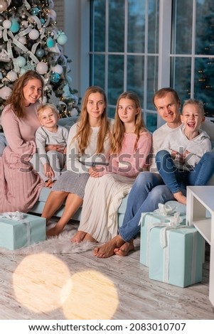 Big Happy family with many kids having fun on the sofa near the Christmas tree. Christmas family eve, christmas mood concept