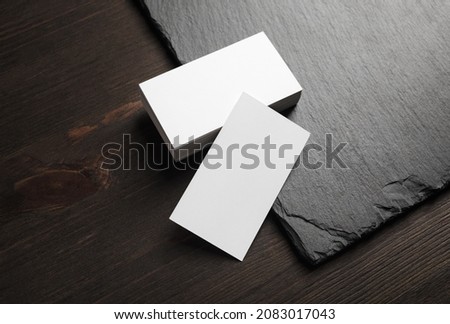 Blank white business cards on stone board background. Copy space.