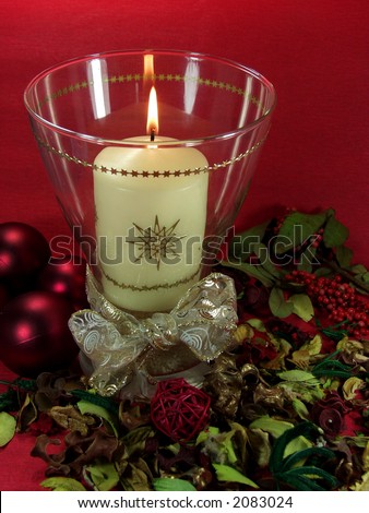 christmas decoration whit candle, balls and flowers on red
