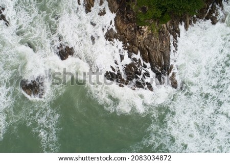 Aerial view of sea crashing waves White foaming waves on seashore rocks Top view fantastic Rocky coast Amazing nature background